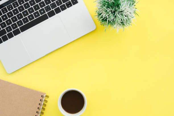 istock Minimal work space - Creative flat lay photo of workspace desk. Top view office desk with laptop, notebooks and coffee cup on pastel color background. Top view with copy space, flat lay photography. 939184332