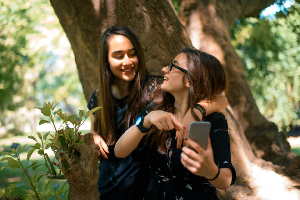 istock Girlfriends browsing on the telephone 939185026