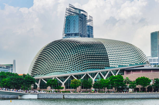 The Esplanade is a massive performing arts center located in the Marina Bay of Singapore. This photo captures the ultra modern building and it's surroundings on a warm sunny day.