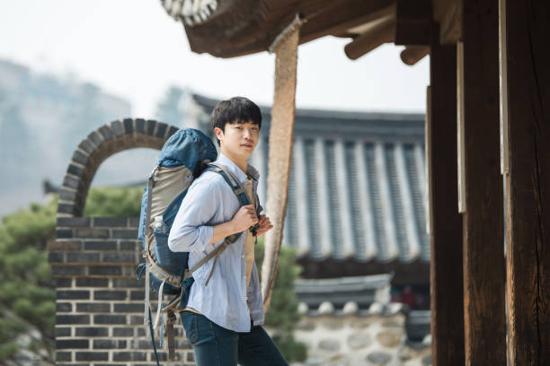 young man doing a backpacking trip in a Korean traditional house.