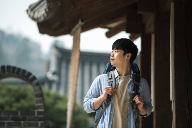istock young man doing a backpacking trip in a Korean traditional house. 939189332