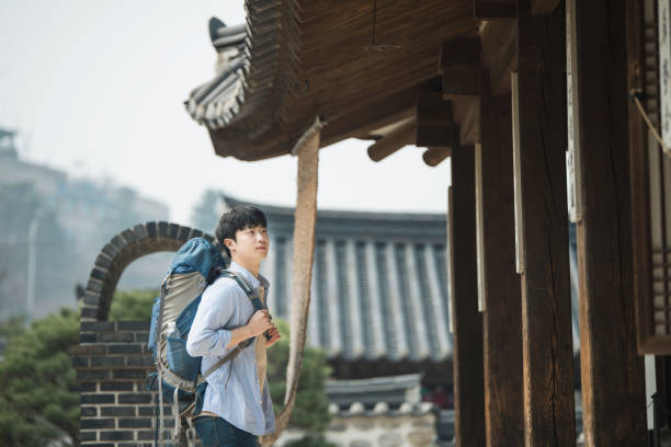 istock young man doing a backpacking trip in a Korean traditional house. 939189334
