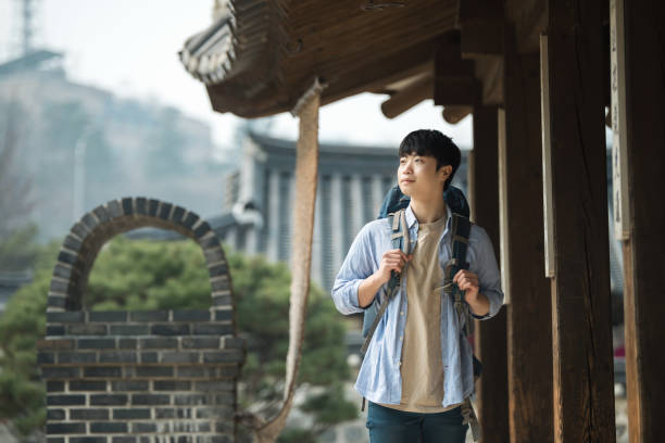 istock young man doing a backpacking trip in a Korean traditional house. 939189360