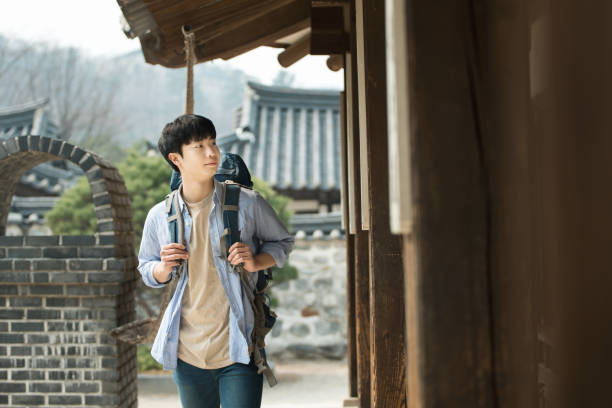 istock young man doing a backpacking trip in a Korean traditional house. 939189366