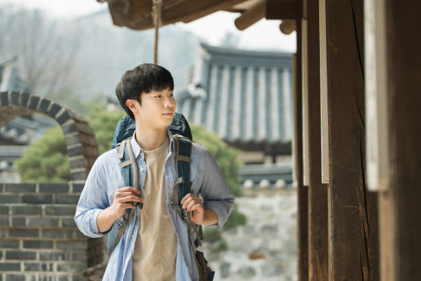 istock young man doing a backpacking trip in a Korean traditional house. 939189368