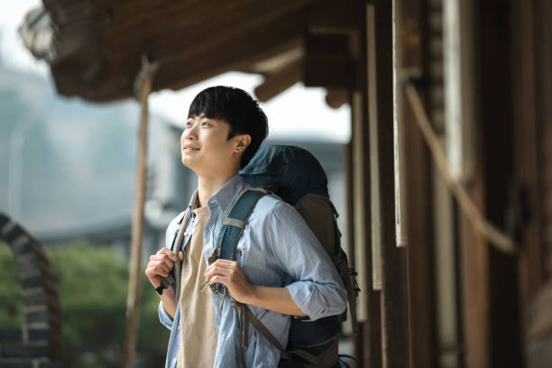 istock young man doing a backpacking trip in a Korean traditional house. 939189372