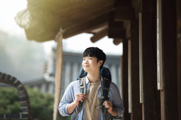 istock young man doing a backpacking trip in a Korean traditional house. 939189406