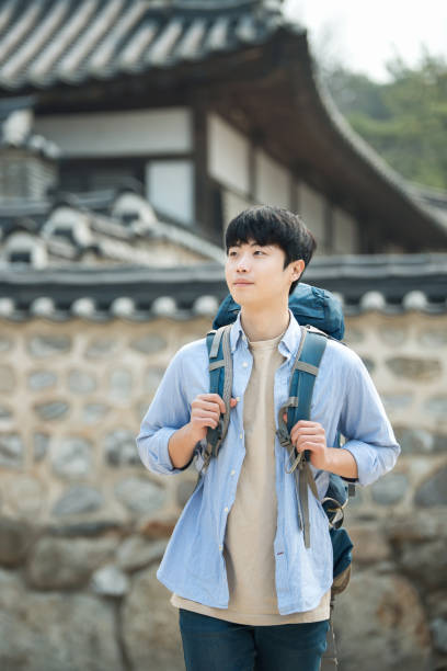 istock young man doing a backpacking trip in a Korean traditional house. 939189502