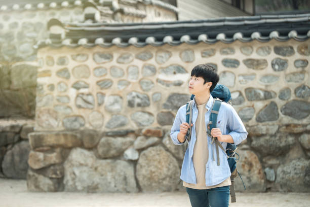 istock young man doing a backpacking trip in a Korean traditional house. 939189504