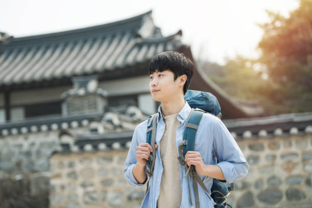 istock young man doing a backpacking trip in a Korean traditional house. 939189518
