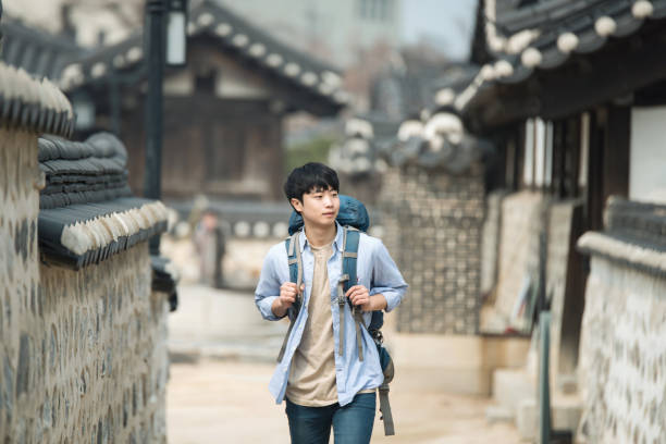 istock young man doing a backpacking trip in a Korean traditional house. 939189606