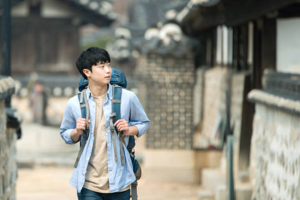 istock young man doing a backpacking trip in a Korean traditional house. 939189628