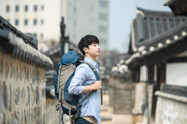 istock young man doing a backpacking trip in a Korean traditional house. 939189646