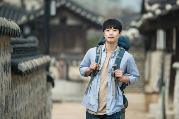istock young man doing a backpacking trip in a Korean traditional house. 939189652