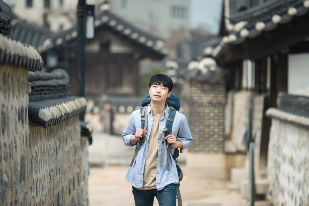 istock young man doing a backpacking trip in a Korean traditional house. 939189654