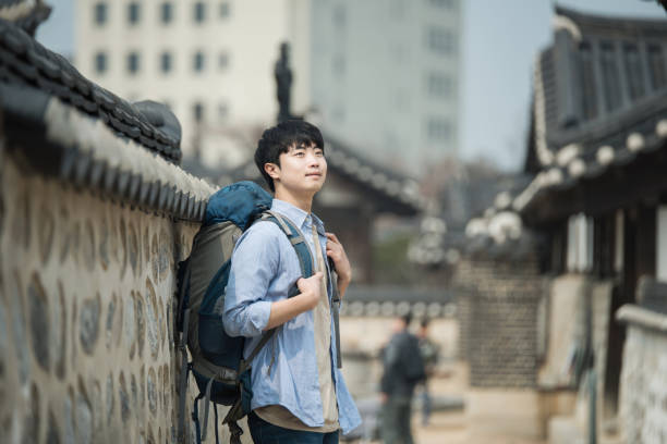 istock young man doing a backpacking trip in a Korean traditional house. 939189676