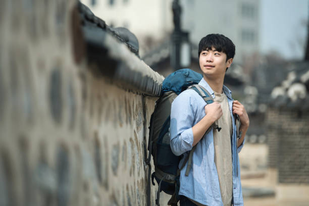 istock young man doing a backpacking trip in a Korean traditional house. 939189698