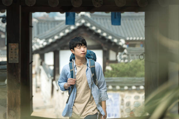 istock young man doing a backpacking trip in a Korean traditional house. 939189700