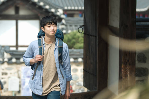 istock young man doing a backpacking trip in a Korean traditional house. 939189704
