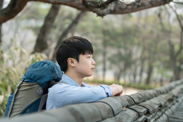 istock young man doing a backpacking trip in a Korean traditional house. 939190432