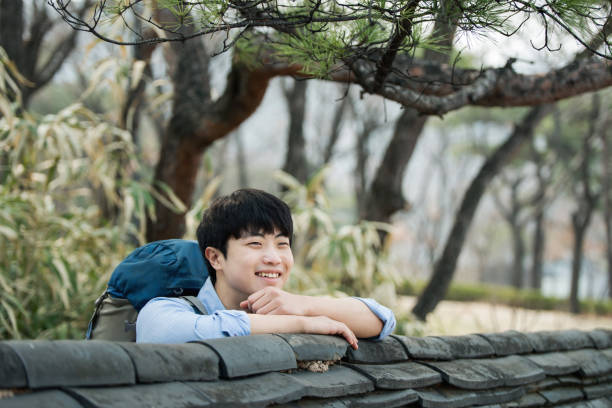 istock young man doing a backpacking trip in a Korean traditional house. 939191738