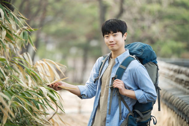 istock young man doing a backpacking trip in a Korean traditional house. 939191774