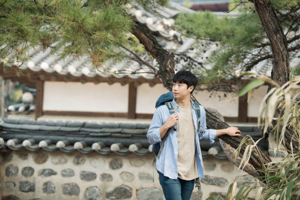 istock young man doing a backpacking trip in a Korean traditional house. 939193856