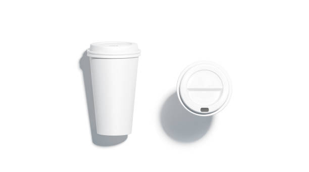 Blank white disposable paper cup lying and stand top view
