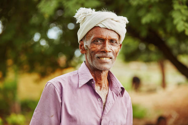 Old age Indian man portrait at farm field.