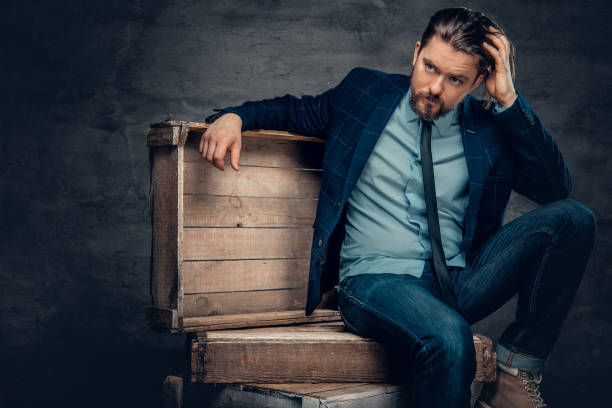 istock A man sits on a wooden box. 939196580