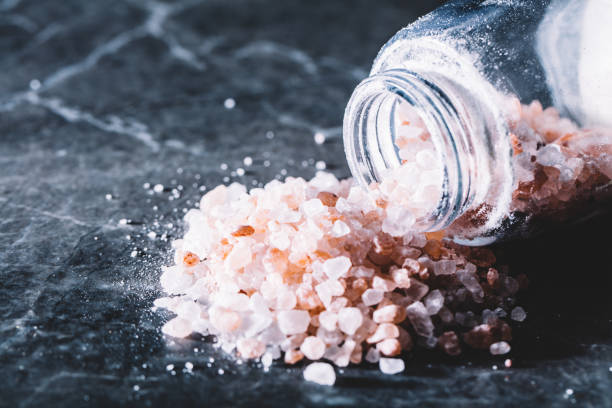 istock Himalayan pink salt spilled from a glass jar 939197406