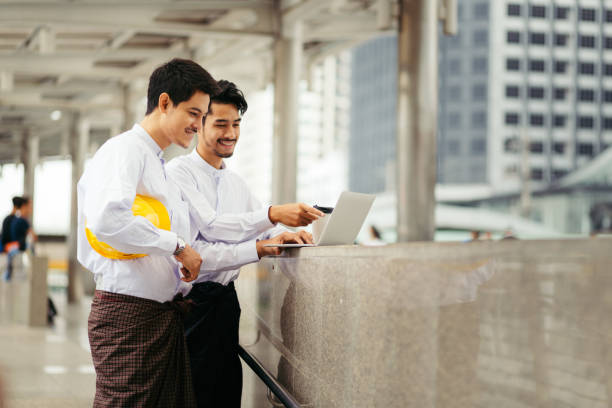 istock Myanmar peoples talking business in city using wireless technology 939201522