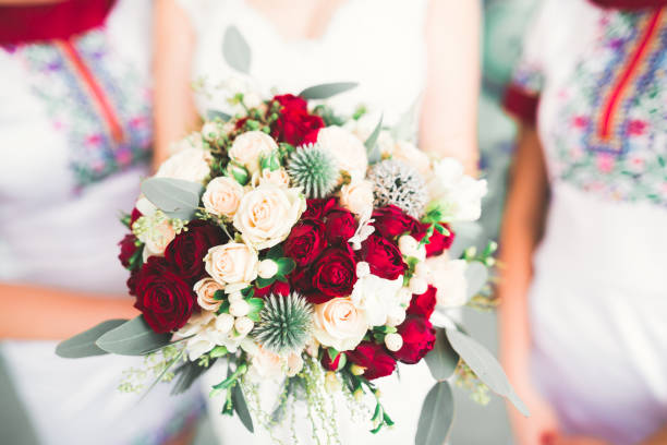 istock Bride holding big and beautiful wedding bouquet with flowers 939202850