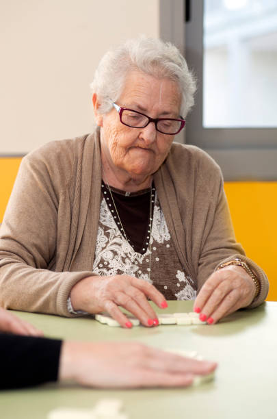 istock Retired Senior woman playing Domino 939205722