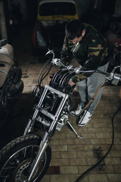 istock Man worker in motorcycle repair shop 939211828