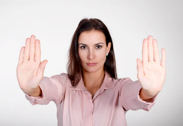istock young woman showing stop 939220094