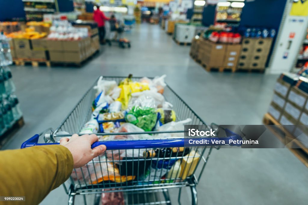 first person view. man with trolley in grocery store. shopping concept Point of View Stock Photo