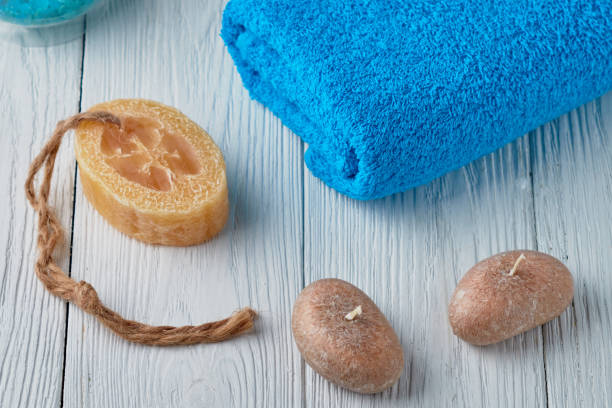 istock Spa concept. Colored towel, scented candles, handmade soaps on a white background. 939231890