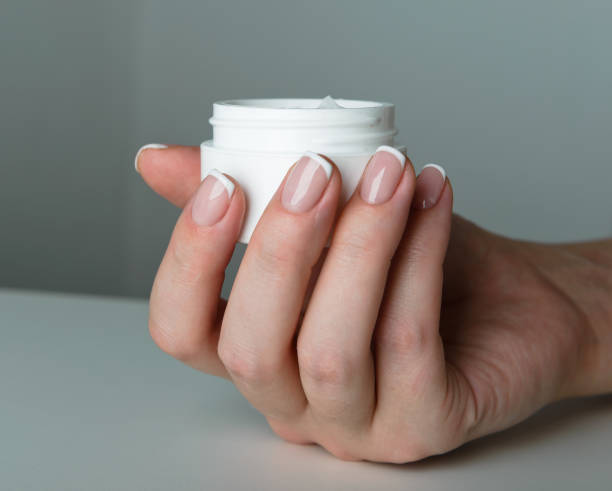 istock beautiful woman hands with cream 939234642