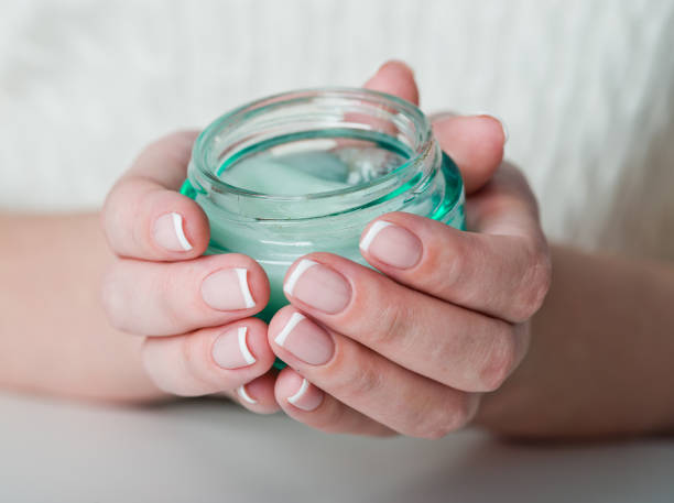 istock beautiful woman hands with cream 939234668