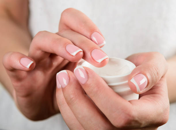 istock beautiful woman hands with cream 939234686