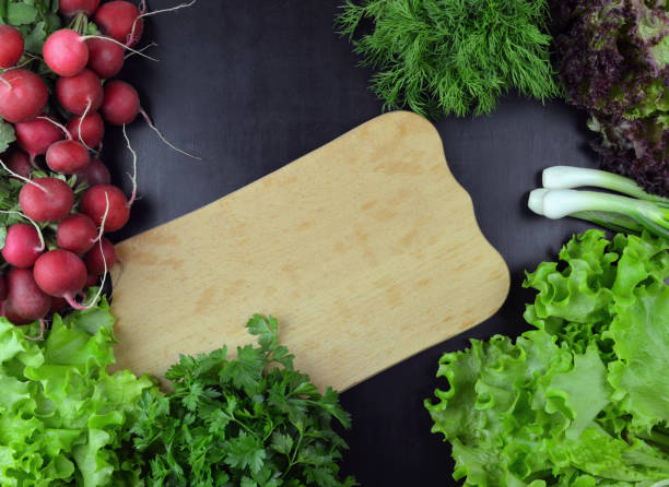 Spinach, dill, cilantro, parsley. Fresh greens on a cutting board.