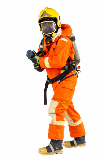Firefighter with mask and air-pack fully protective suit and working with fog nozzle. Isolated on white background