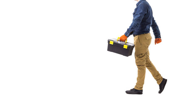istock repairman (builder) holds the tool box in his hand isolated on white background with copy space 939236234