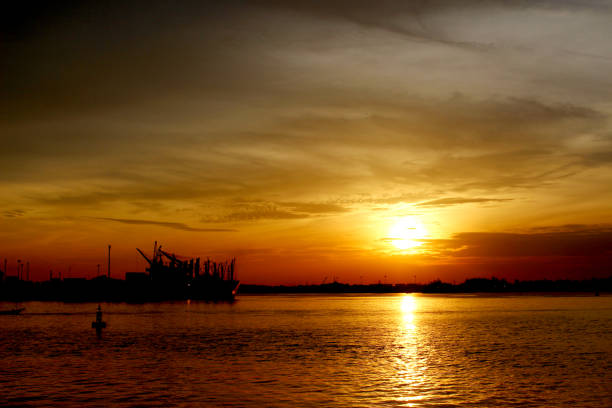 istock silhouette of a cargo ship on the sea 939239012