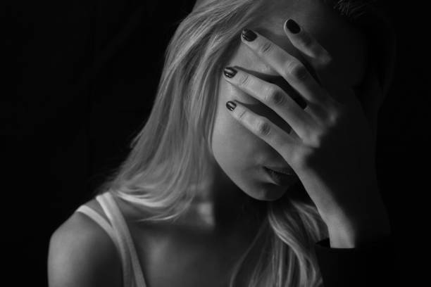 istock Sad woman in dark place 939240220