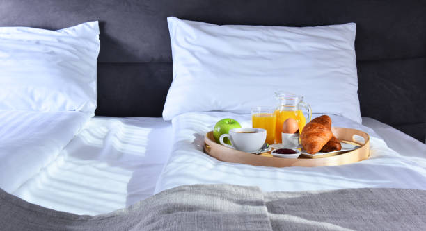 istock Breakfast on tray in bed in hotel room 939242822