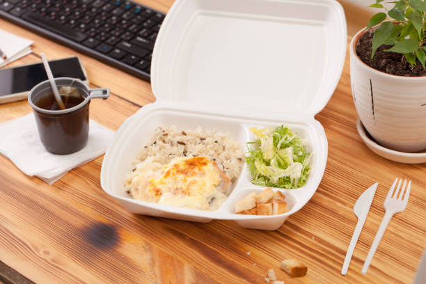 istock Container for food on a wooden table in the office 939244330