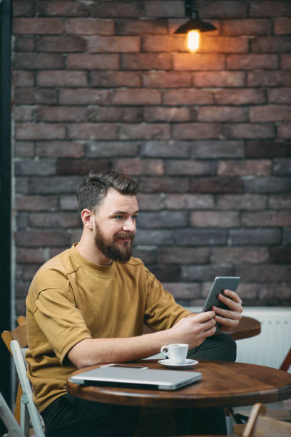 istock Young man sitting in cafeteria. 939245142