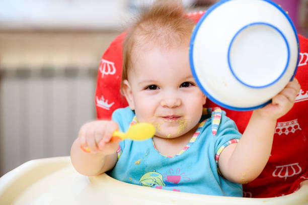 istock One year old child plays in the kitchen with dishes 939250618